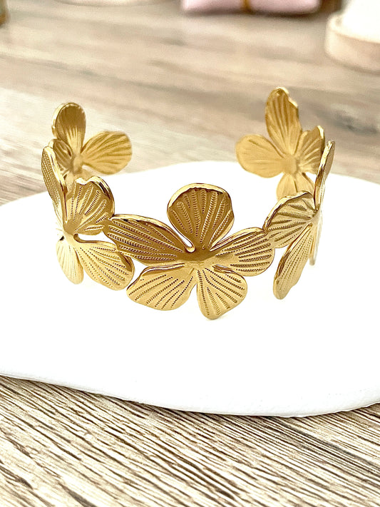 Jonc Félicia, fleurs en acier inoxydable doré.