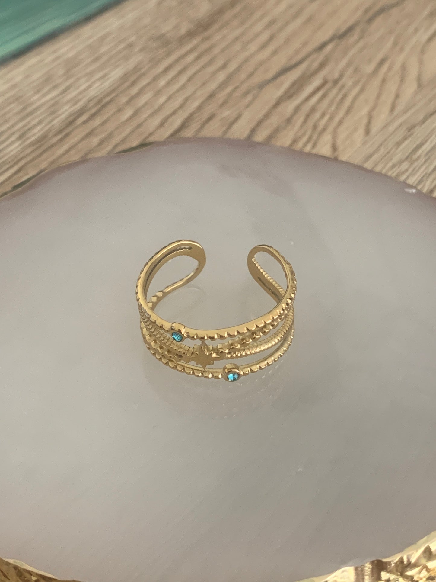 Bague Mélodie, ouverte réglable avec une étoile et deux strass colorés bleu, acier inoxydable doré.